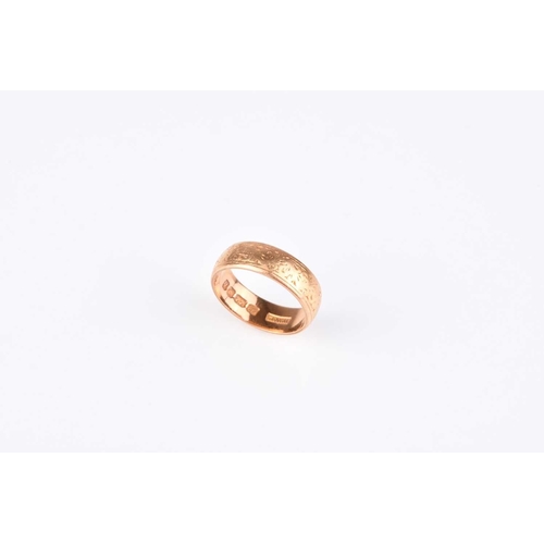 110 - A 22ct gold wedding band, with engraved decoration, ring size J 1/2, hallmarked London 1963, weight ... 