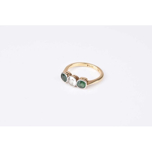 112 - A diamond and green stone ring, designed as a central old cut diamond flanked to each side by a roun... 