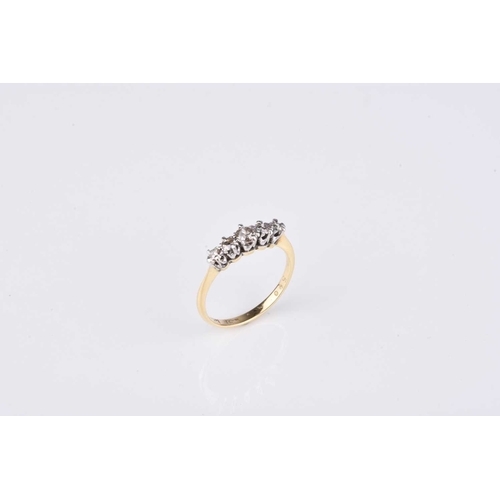 114 - A graduated five stone diamond ring, the brilliant cut diamonds claw set in white metal to yellow me... 