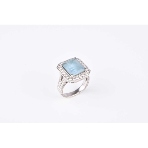 119 - An aquamarine and diamond cluster ring, designed as a central rectangular faceted aquamarine claw se... 