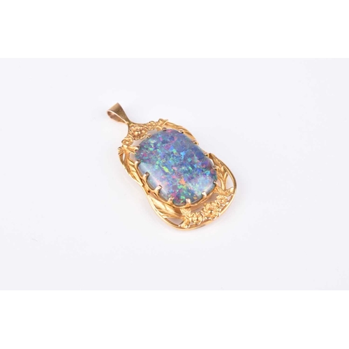 134 - An opal doublet pendant, the oval opal doublet plaque set to yellow metal decorative floral pendant ... 