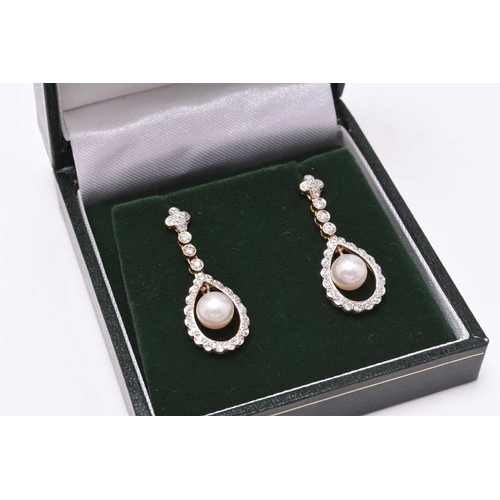 135 - A pair of Edwardian style 18ct gold cultured pearl and diamond ear pendants, each designed as a sing... 