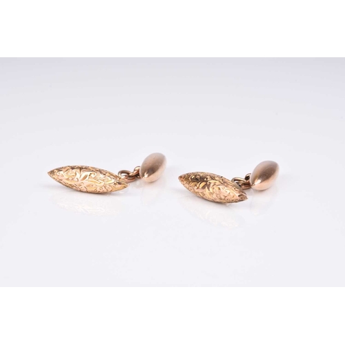 146 - A pair of Edwardian 9ct gold cufflinks, of torpedo form with bright cut engraved decoration, hallmar... 