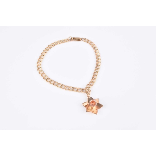 157 - A Clogau 9ct gold Daffodil charm bracelet, the yellow gold double curb bracelet suspending Daffodil ... 