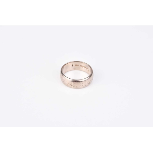 165 - An 18ct white gold wedding band, with bright cut engraved decoration, hallmarked London 1973, ring s... 