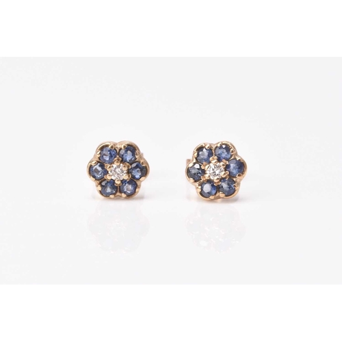 176 - A pair of 9ct gold sapphire and diamond cluster stud earrings, each designed as a central diamond wi... 