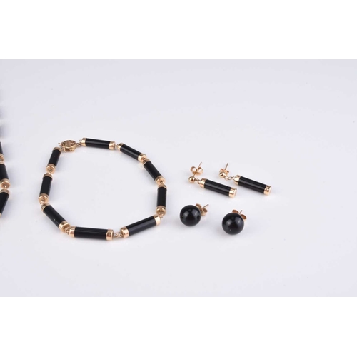 186 - A suite of 9ct gold mounted black hardstone set jewellery, comprising; a necklace, 40cm long, a brac... 