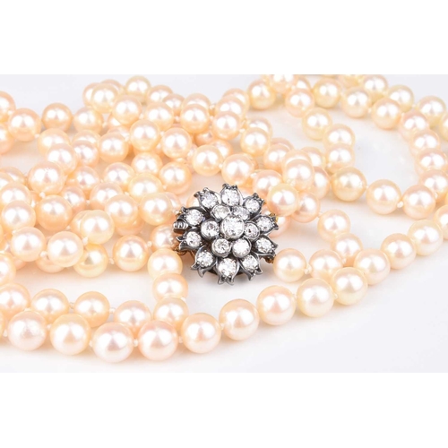 196 - A two strand cultured pearl necklace with diamond set clasp, the uniform cultured pearls each measur... 