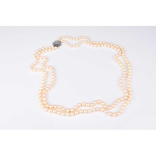 196 - A two strand cultured pearl necklace with diamond set clasp, the uniform cultured pearls each measur... 