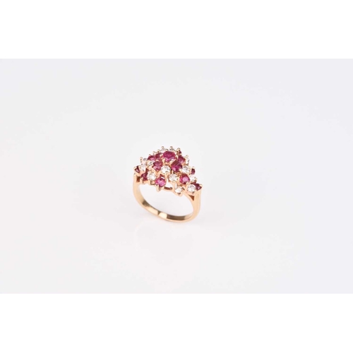 213 - A ruby and diamond cluster ring, designed as a raised cluster of thirteen round mixed cut rubies and... 