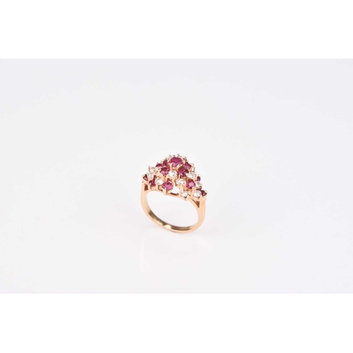 213 - A ruby and diamond cluster ring, designed as a raised cluster of thirteen round mixed cut rubies and... 