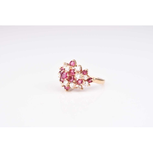 213 - A ruby and diamond cluster ring, designed as a raised cluster of thirteen round mixed cut rubies and... 