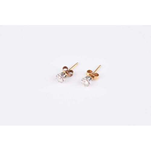 215 - A pair of diamond stud earrings, the brilliant cut diamonds claw set in white metal with yellow meta... 