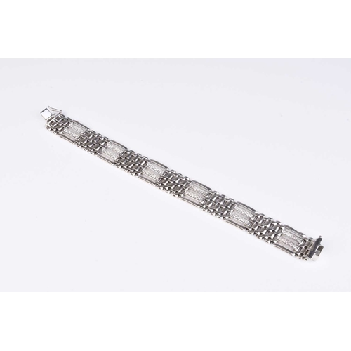 237 - A diamond set gate link bracelet, designed as alternating diamond and brick links with integral push... 