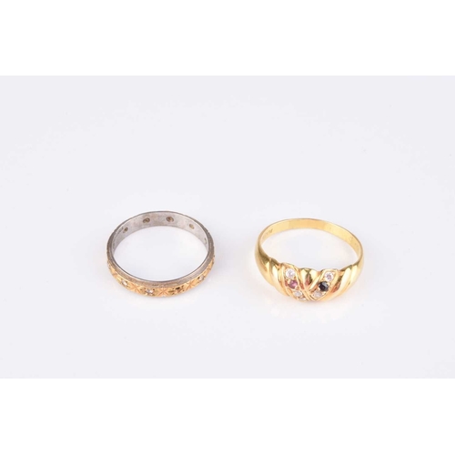 239 - An 18ct yellow and white gold stone band, size Q ½, weight approx. 2.8g, together with a yellow meta... 