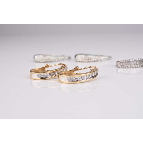 252 - A pair of yellow metal diamond set hoop earrings, stamped '14k', together with a pair of white metal... 