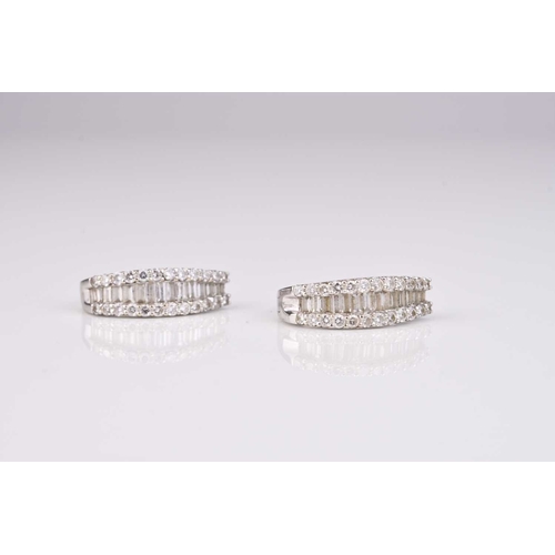 252 - A pair of yellow metal diamond set hoop earrings, stamped '14k', together with a pair of white metal... 