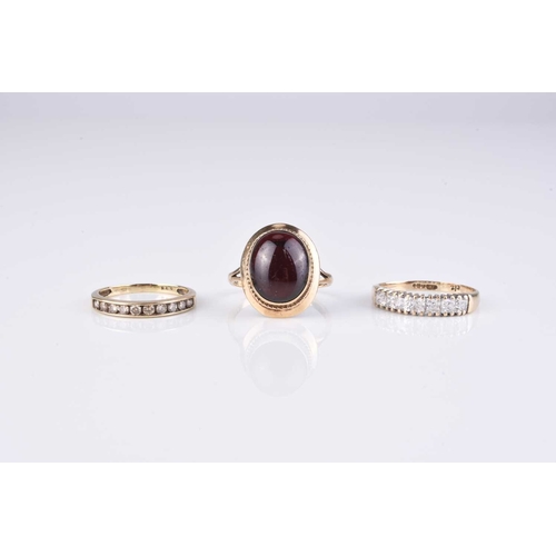 254 - Three 9ct gold stone set rings, comprising; a cabochon garnet example, size L, a diamond set example... 