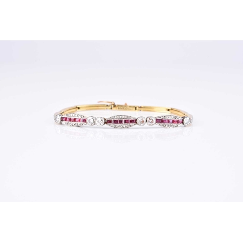 257 - An early 20th century diamond and ruby bracelet, designed as three oval panels set with square cut r... 