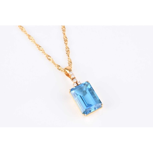 261 - A blue topaz and diamond pendant on chain, the pendant designed as a large rectangular faceted blue ... 