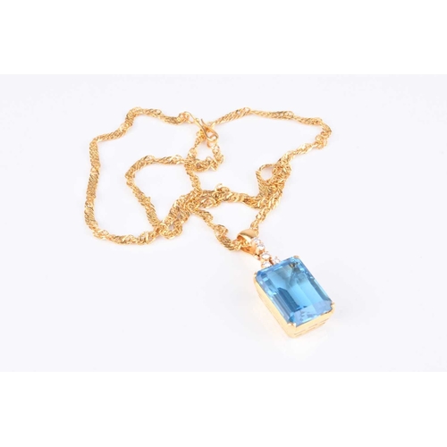 261 - A blue topaz and diamond pendant on chain, the pendant designed as a large rectangular faceted blue ... 