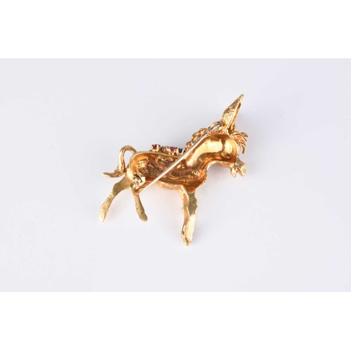 263 - An 18ct yellow gold gem set novelty donkey brooch, the donkey's saddle set with diamonds, sapphires,... 