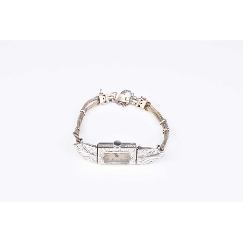 292 - An Art Deco diamond set bracelet watch, the engine turned shaped rectangular dial with Arabic numera... 