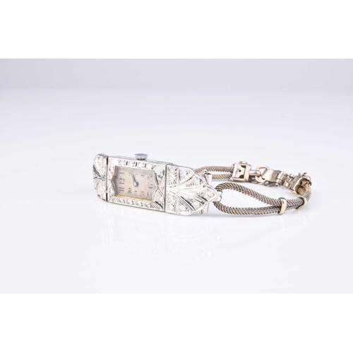 292 - An Art Deco diamond set bracelet watch, the engine turned shaped rectangular dial with Arabic numera... 