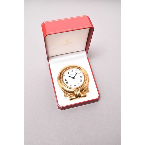 312 - Cartier: A gilt brass desk alarm clock Date: Circa 2000 Movement: Quartz Dial: White, black Roman nu... 