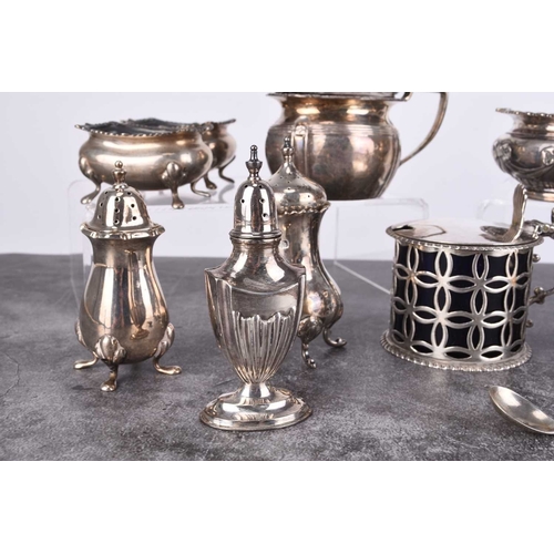 32 - A collection of silver cruets, comprising; a pierced drum mustard with blue glass liner, a pair of o... 