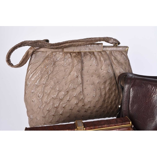 362 - A group of vintage handbags and purses Including two tan crocodile pattern leather clutch bags, an E... 