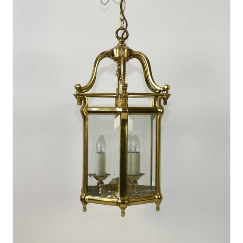 383 - A reproduction brass lantern ceiling light Of hexagonal form with bevelled glass to each side, fitte... 