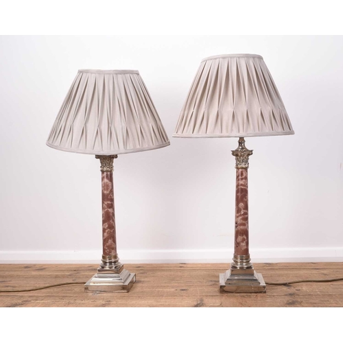 384 - A pair of electroplate and variegated pink marble Corinthian column table lamps On stepped square ba... 