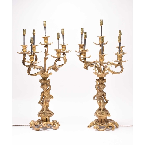 385 - A pair of ormolu rococo revival figural candelabra table lights 19th/20th century, the six branches ... 