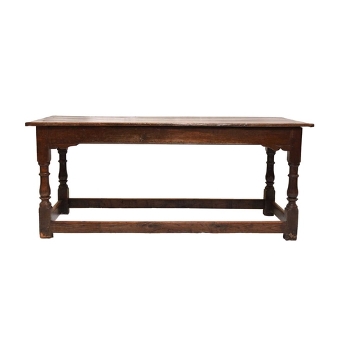 389 - A late 17th century oak refectory type dining table The boarded top above a plain frieze, raised on ... 