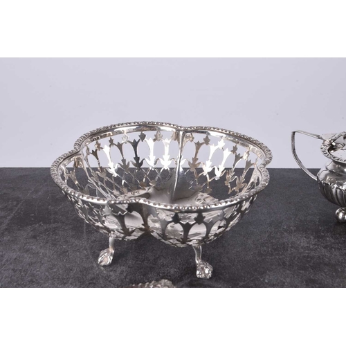 39 - A small collection of silver, comprising; a lobed pierced bowl, a three piece cruet set, a mustard a... 