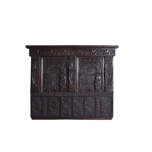 391 - A 17th century and later carved oak part headboard or overmantel The lunette carved cornice frieze a... 