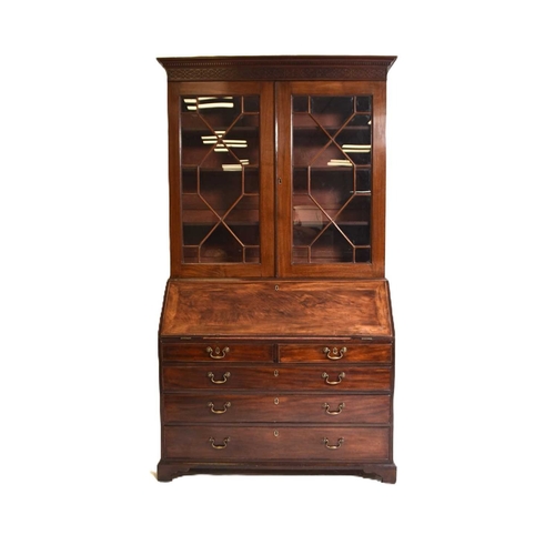 395 - A George III mahogany bureau bookcase The dentil cornice above a blind fretwork frieze and twin astr... 