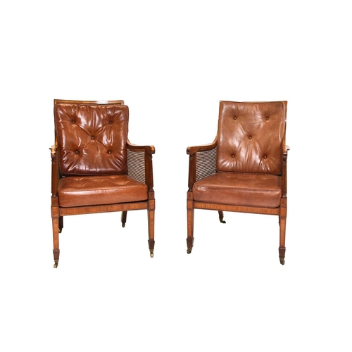 397 - A pair of 19th century caned bergère library chairs With drop-in leather back and seat cushions, the... 