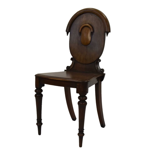 398 - A Victorian mahogany hall chair The oval back with shield cartouche, the moulded seat raised on ring... 