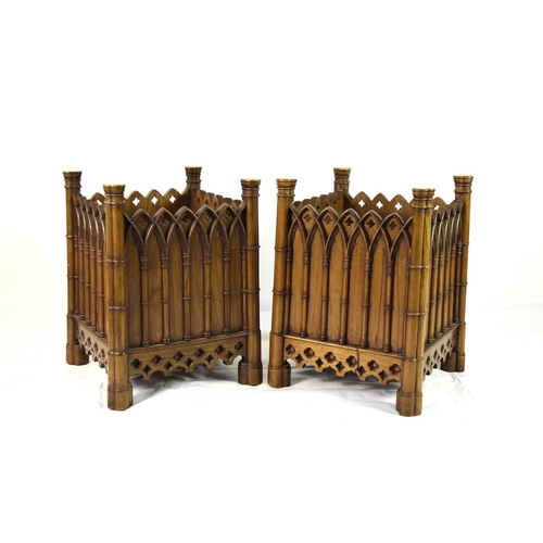 401 - A pair of Gothic revival walnut jardinieres Of cuboid form, carved with arched architectural mouldin... 