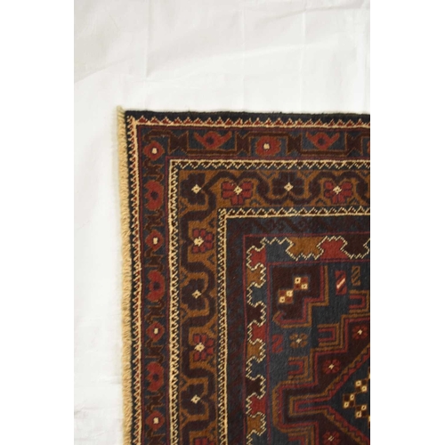 410 - A Balluchi tribal rug, Afghanistan With three dark red geometric medallions on a dark blue ground, w... 