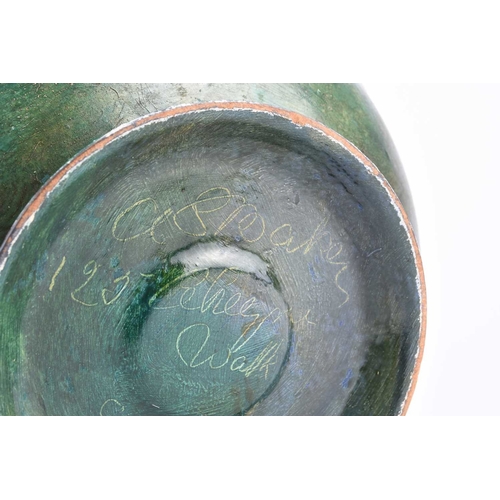 415 - A pewter-mounted painted wood bowl, circa 1900 Of rounded form, the pewter rim embossed with lilies ... 