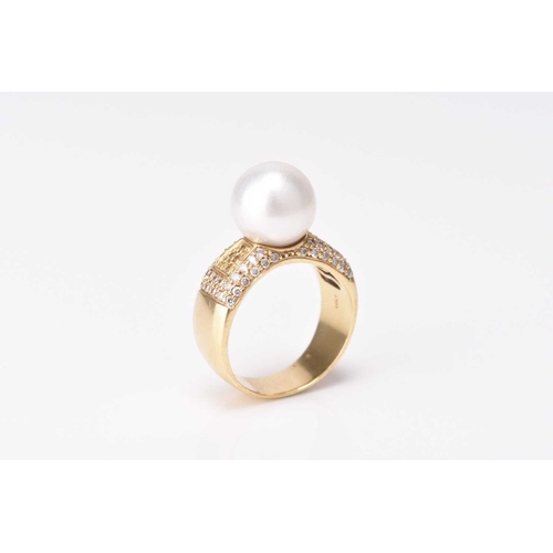 46 - A pearl and diamond ring, designed as a single cultured pearl measuring approx 12mm diameter mounted... 