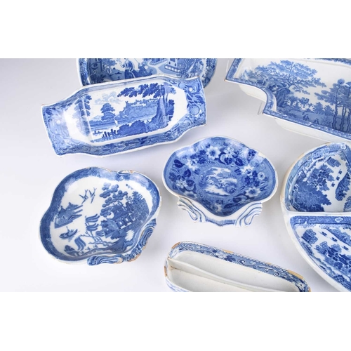 478 - A collection of English blue and white earthenware, early 19th century, comprising a compartmentaliz... 