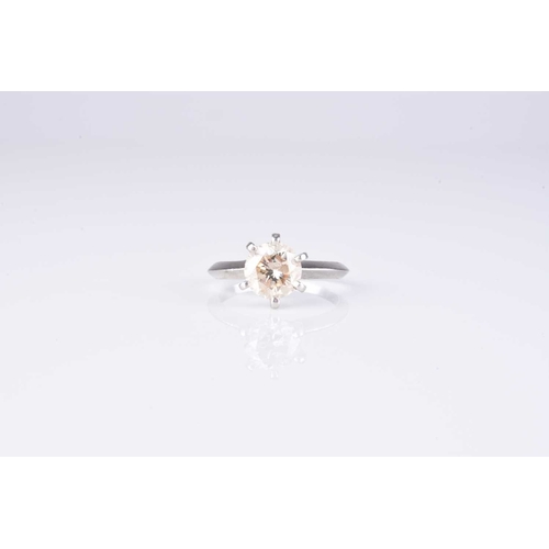 48 - A single stone diamond ring, the brilliant cut diamond claw set in white metal, stamped 'PT 950', ri... 