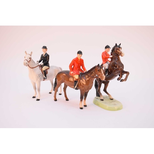 558 - A group of Beswick hunting figures, comprising huntsman in red jacket on brown gloss horse, huntsman... 