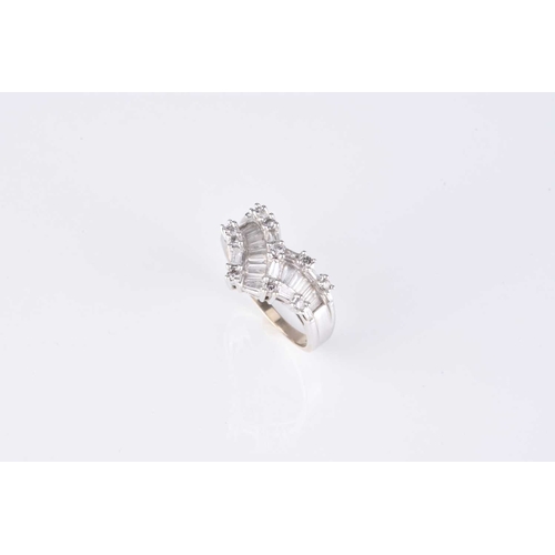 56 - A graduated tapered baguette and brilliant cut diamond ring, of herringbone design, the white metal ... 