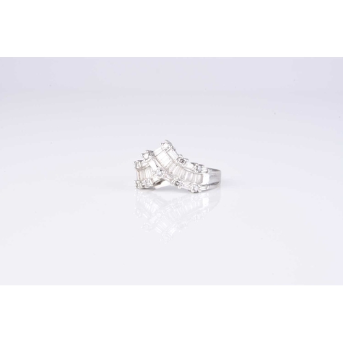 56 - A graduated tapered baguette and brilliant cut diamond ring, of herringbone design, the white metal ... 