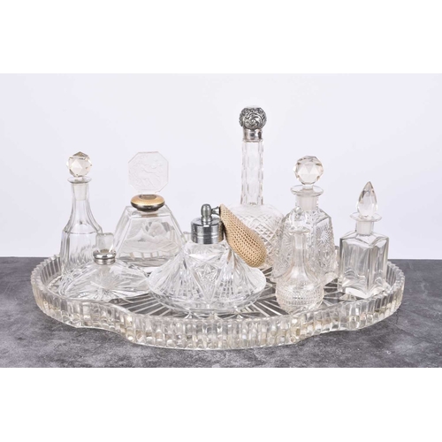 6 - A silver sauce boat, Birmingham 1934, together with three silver mounted glass dressing table jars, ... 